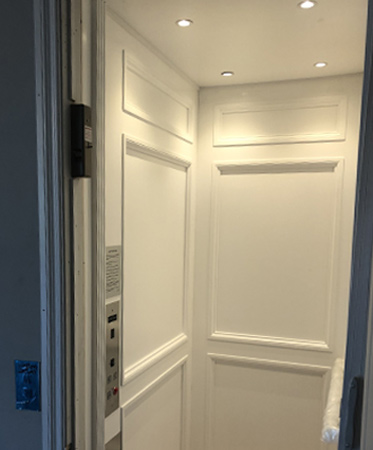 Residential elevator with a control panel on the left in Louisville